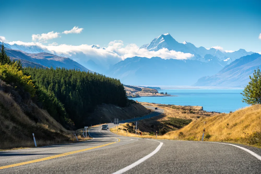 Winding road heading toward Mt Cook past Lake Pukaki, Aotearoa New Zealand